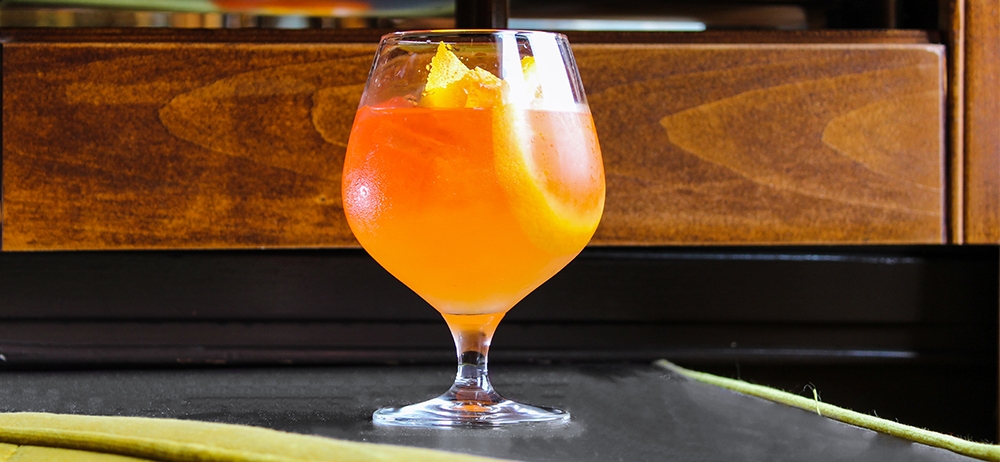 A cocktail with orange slices