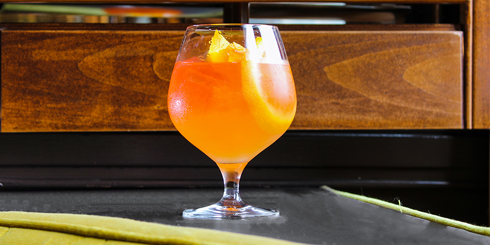 A cocktail with orange slices