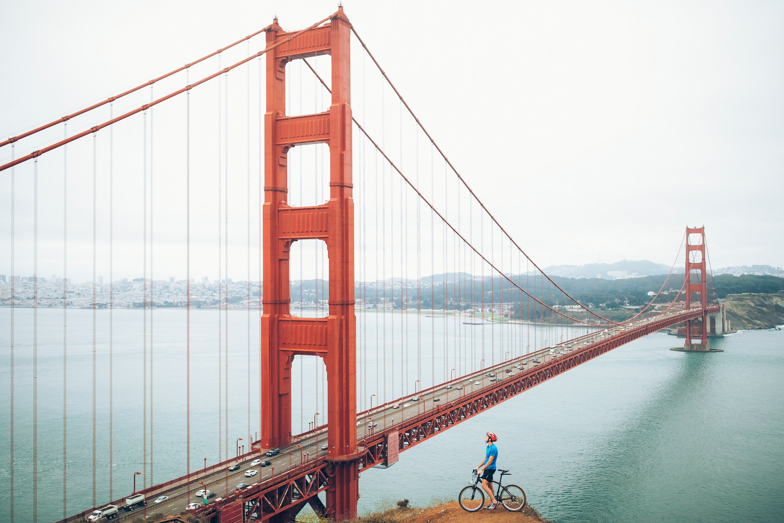 man on hill in font o golden gate bridge