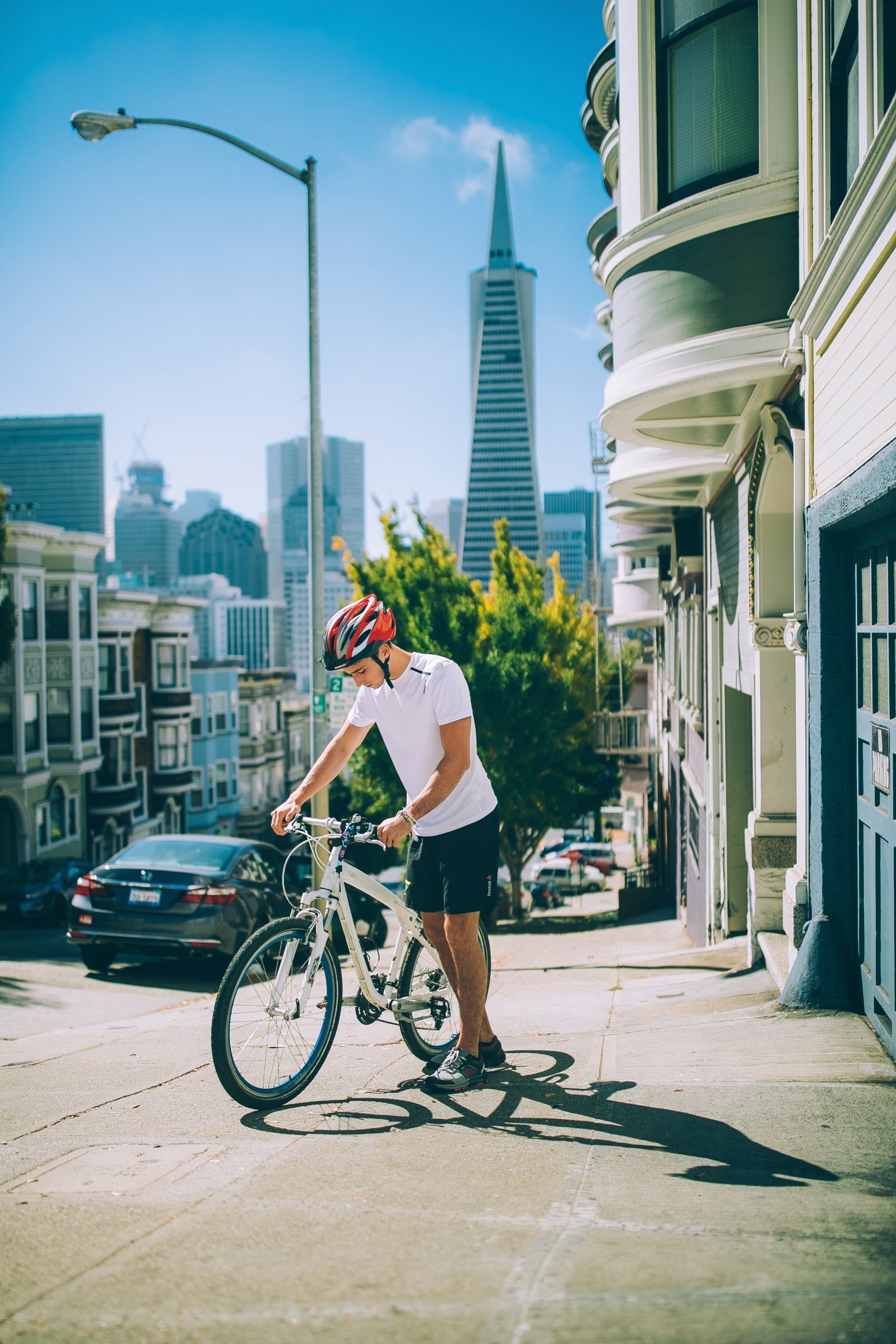 A man pushing a bicycle up a hill
