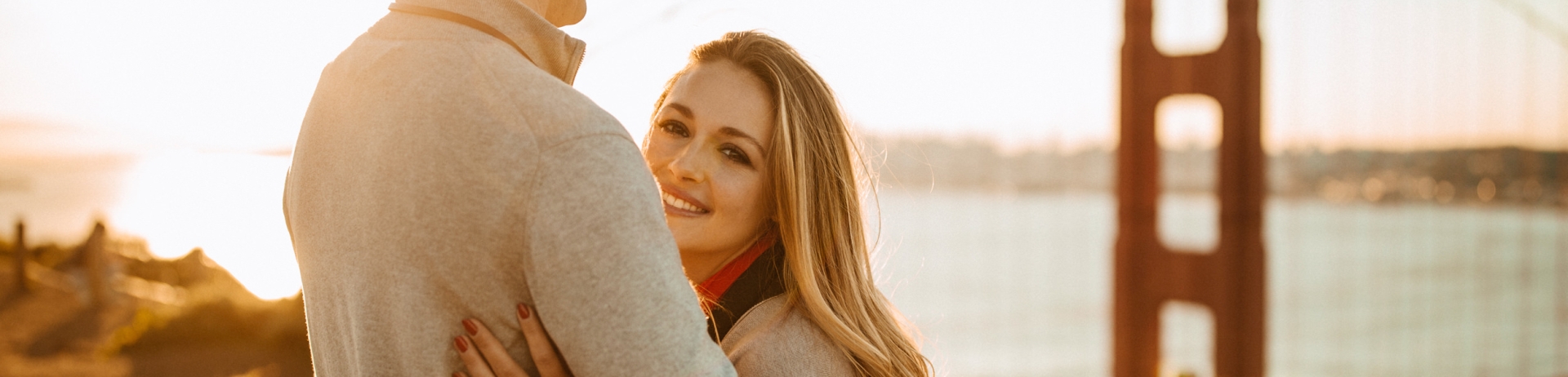 couple hugging with golden gate bridge in the background