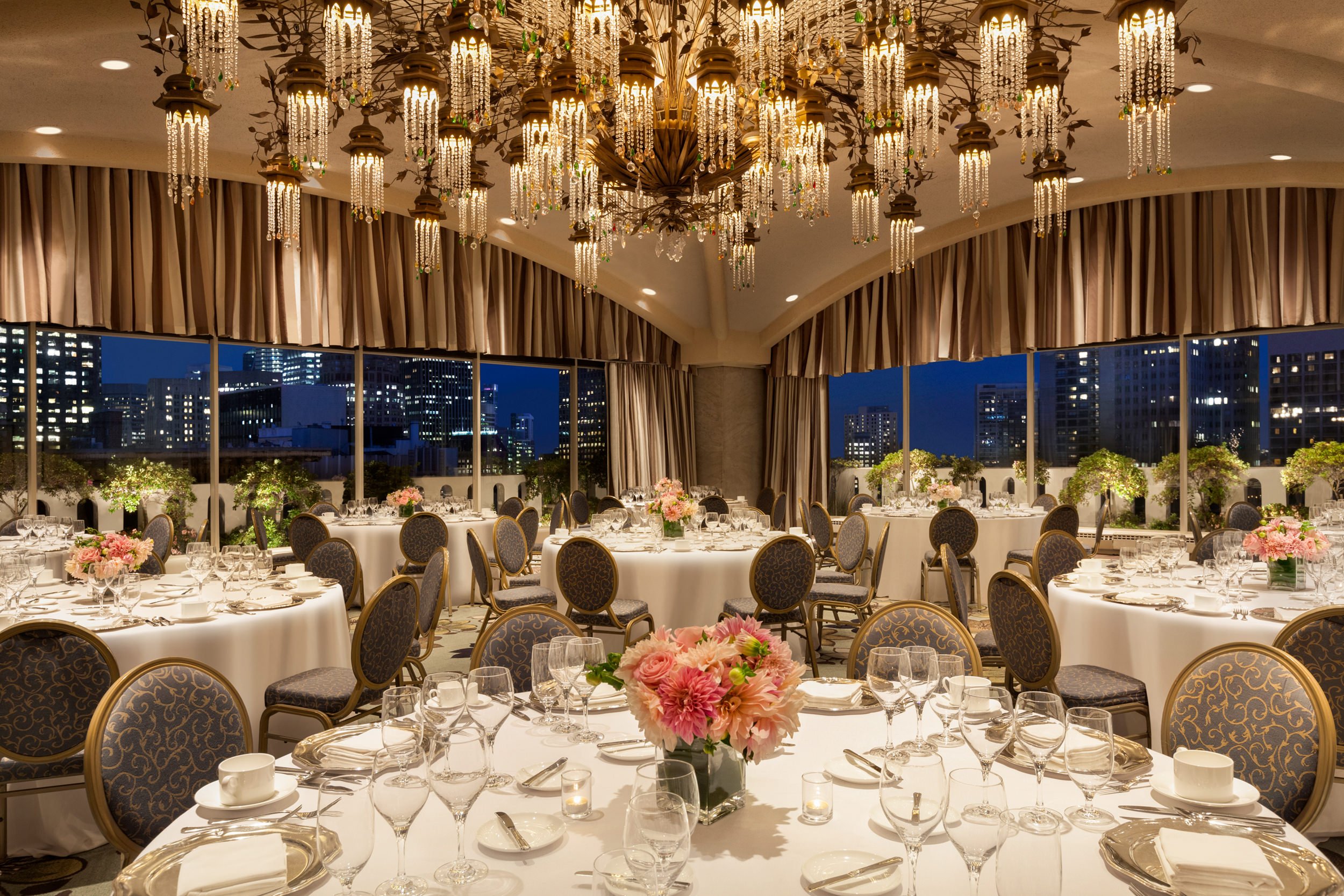 The round table was set with cutlery and wine glasses