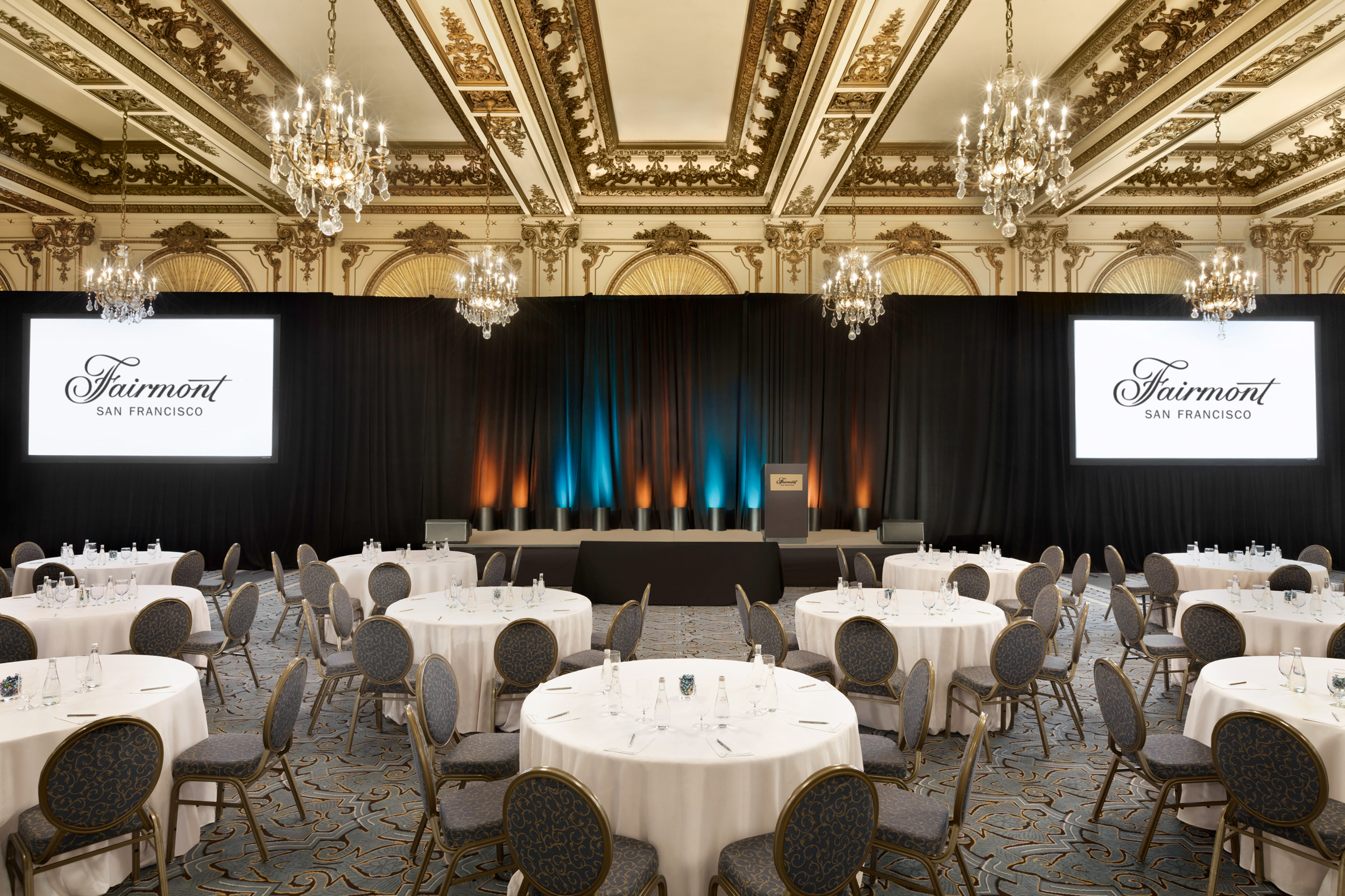 A room with a round table and a stage