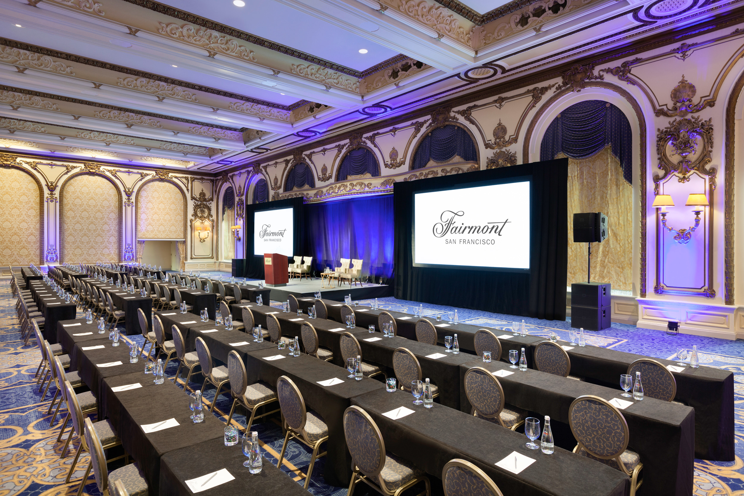 A meeting room filled with long tables