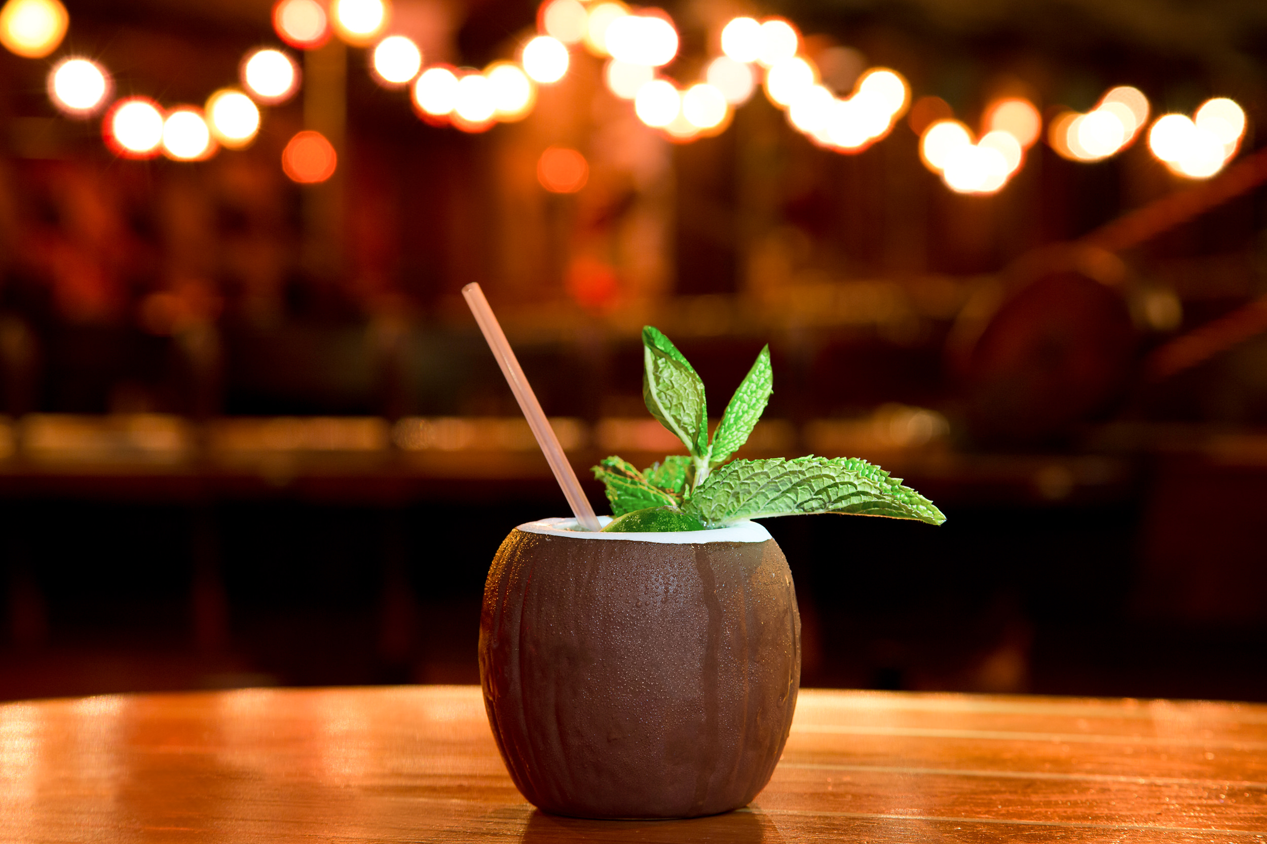 Coconut shell cocktail are garnished with mint leaves