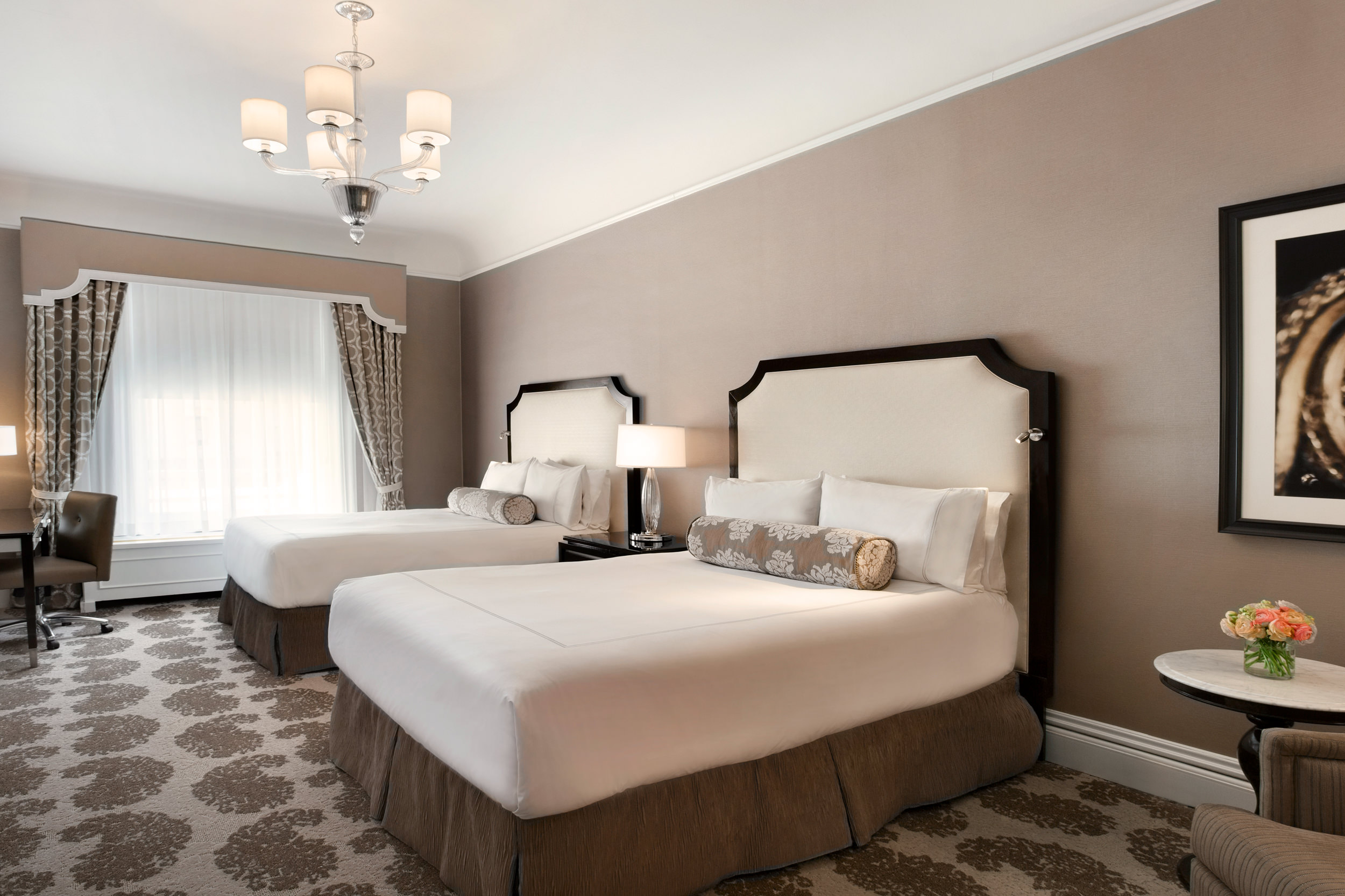 The light brown room has two double beds