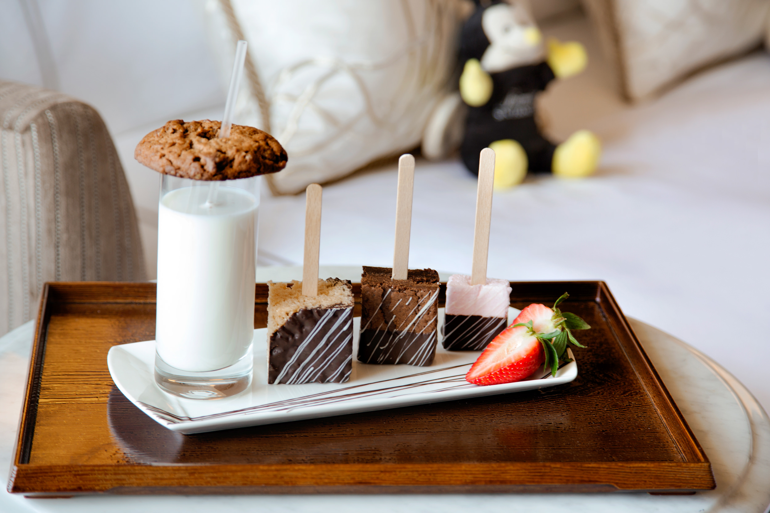 A plate of dessert and a glass of milk with cookies on top