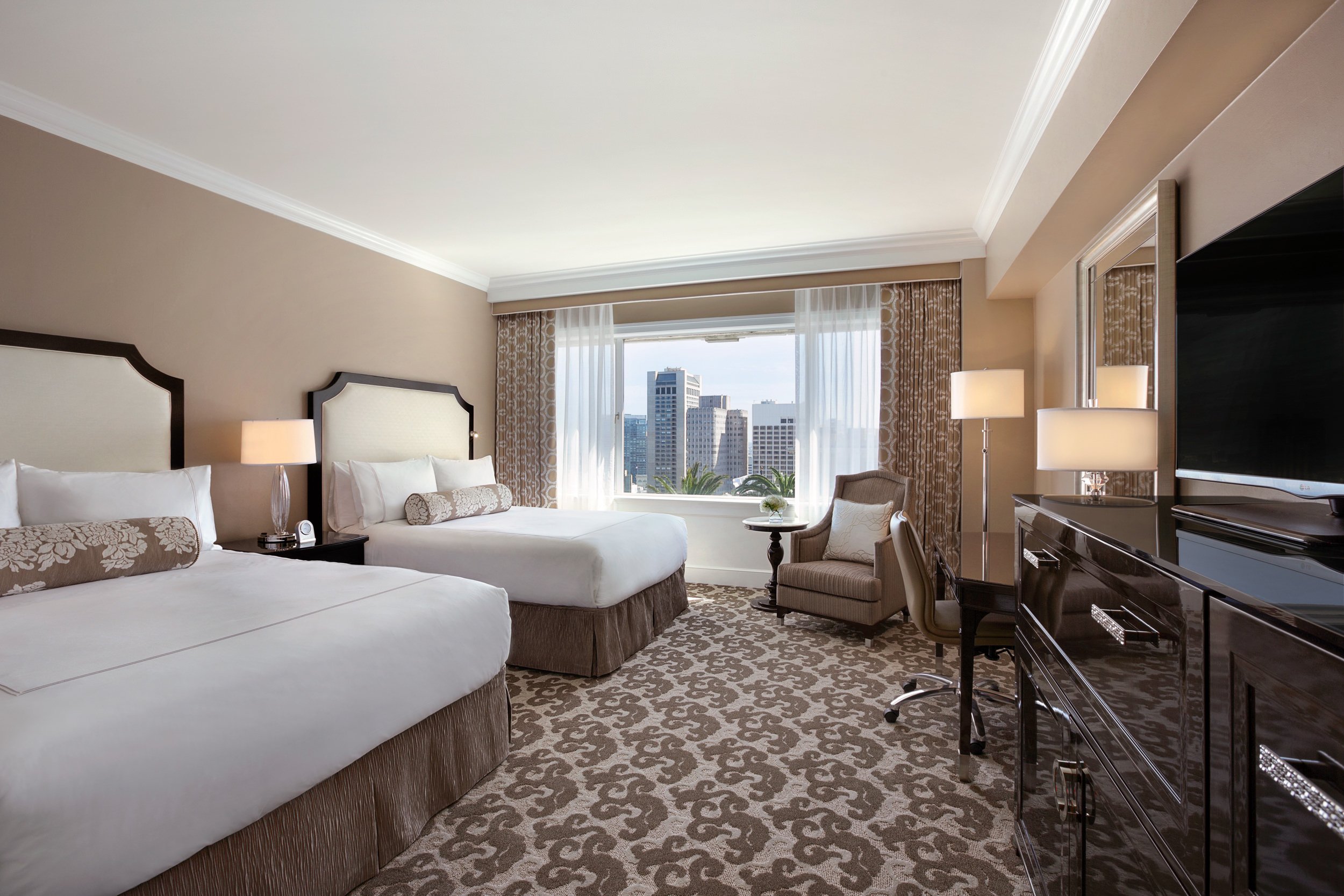 The light brown room has two beds