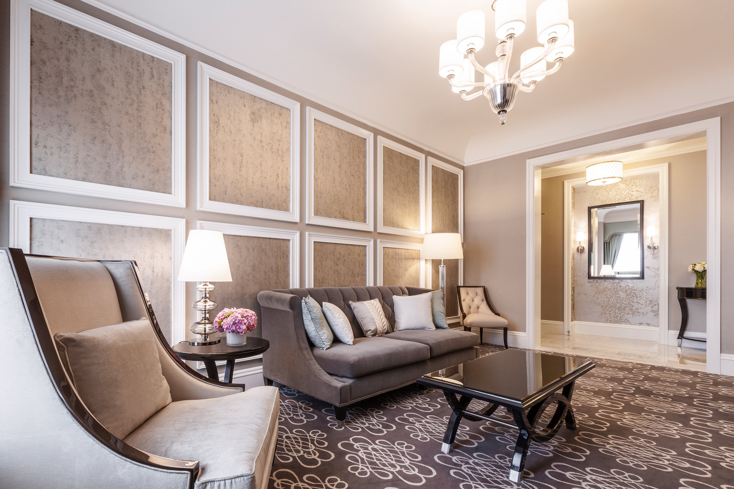 A room with sectional sofas and end tables