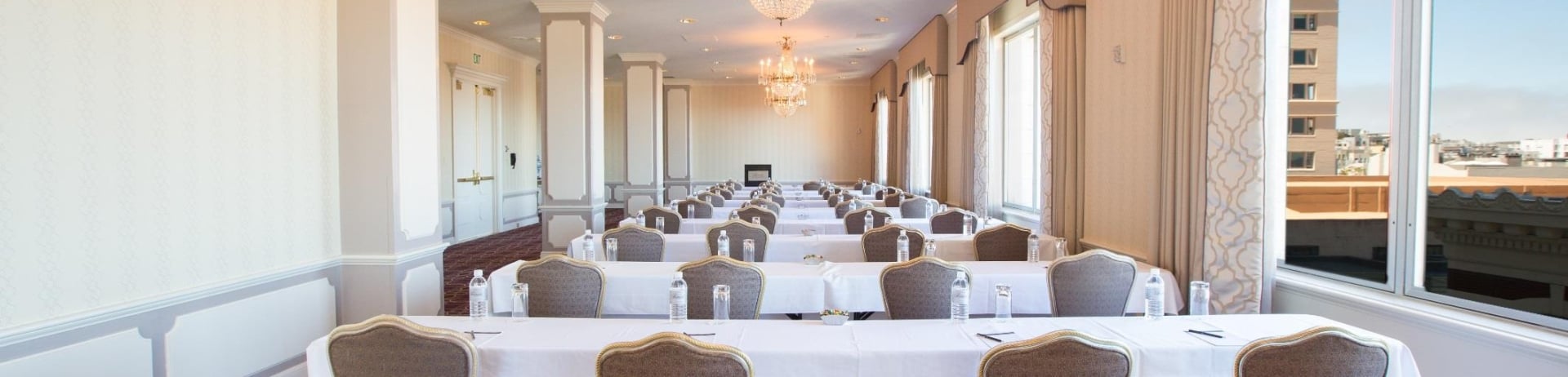 long room with rows of tables set up for a meeting