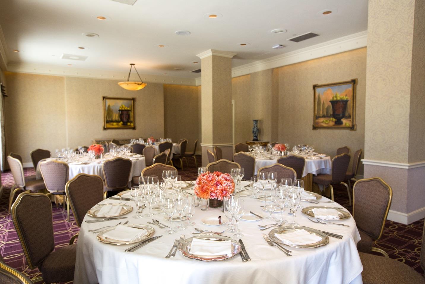 room set up with round tables and orange center pieces