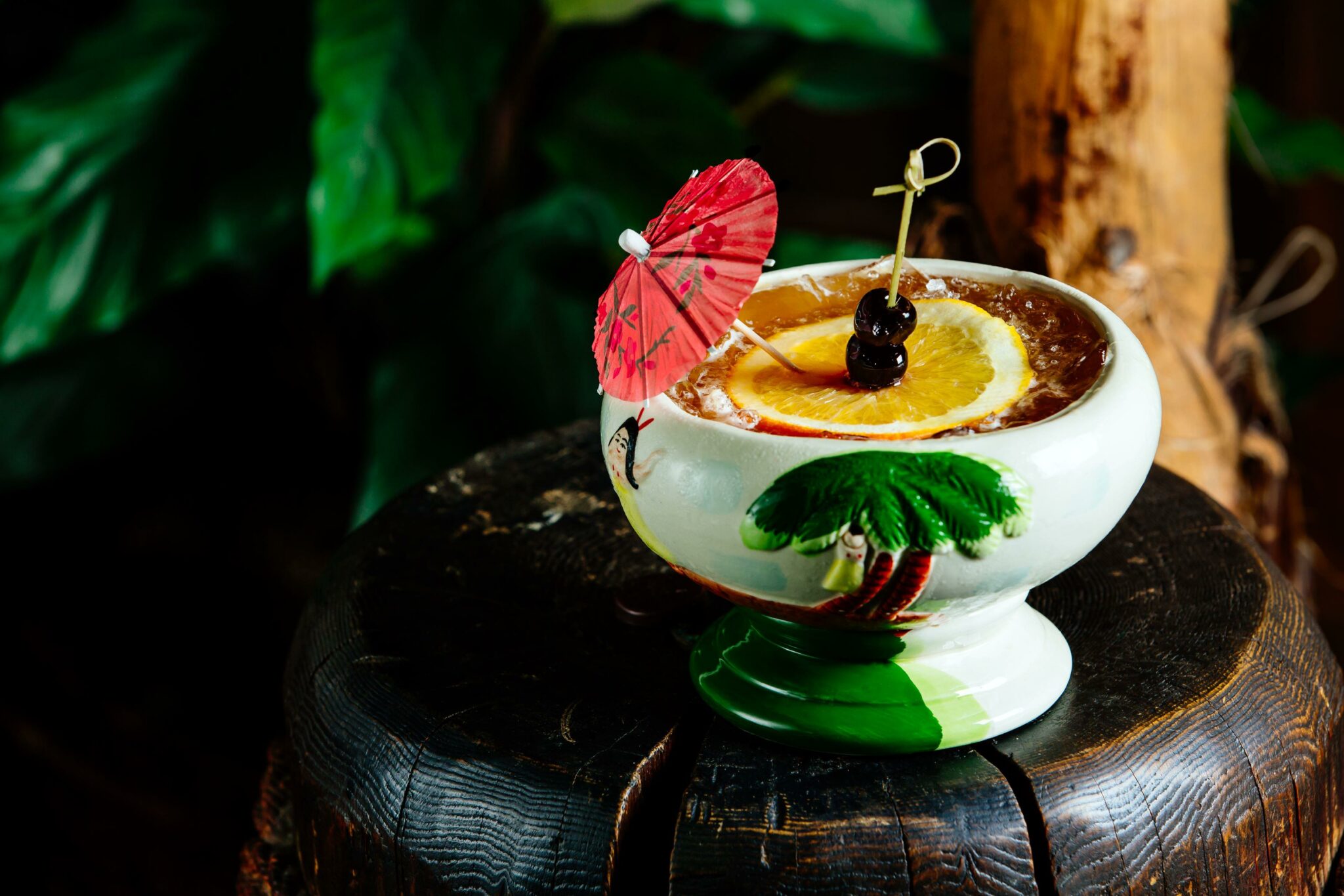 Cocktails with orange slices and garnished umbrellas