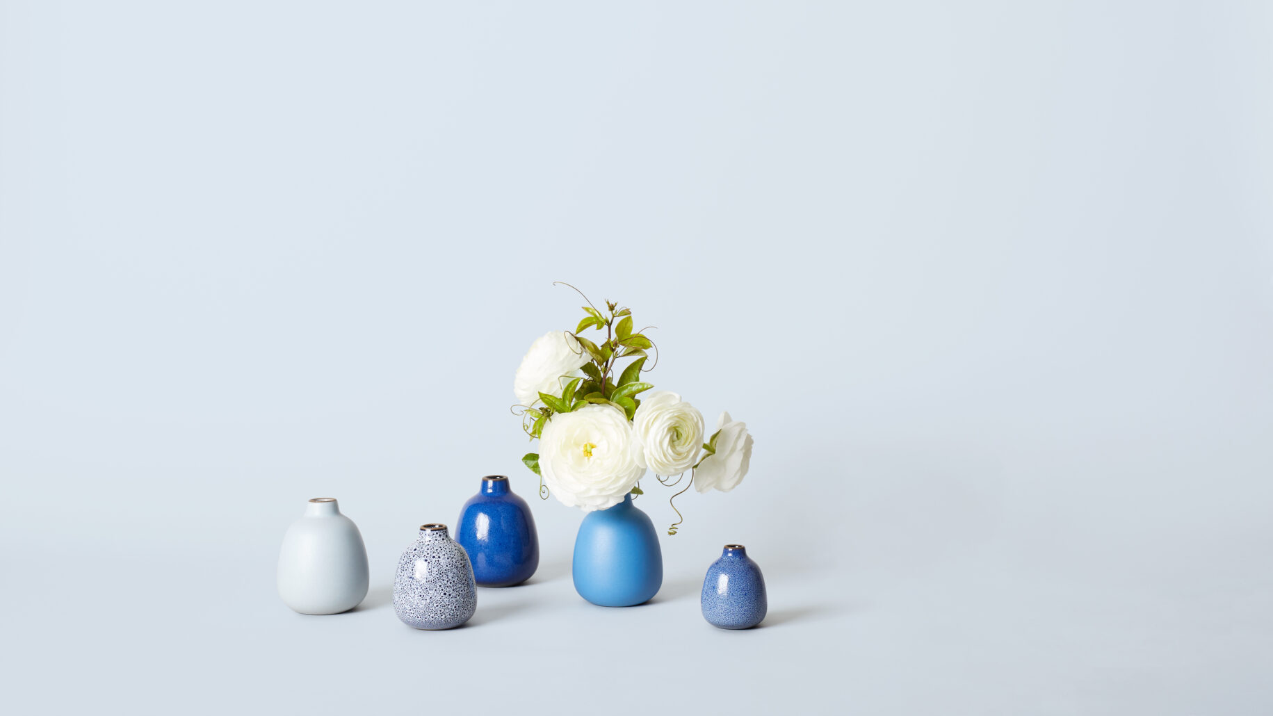A bunch of white flowers in a blue bottle