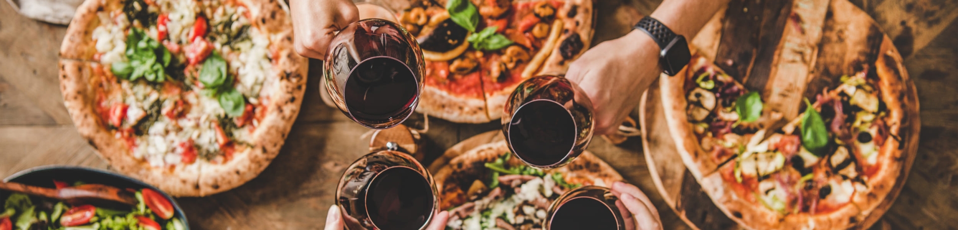 people enjoying pizza and wine