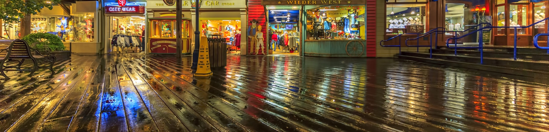 lit up shops on a boardwalk