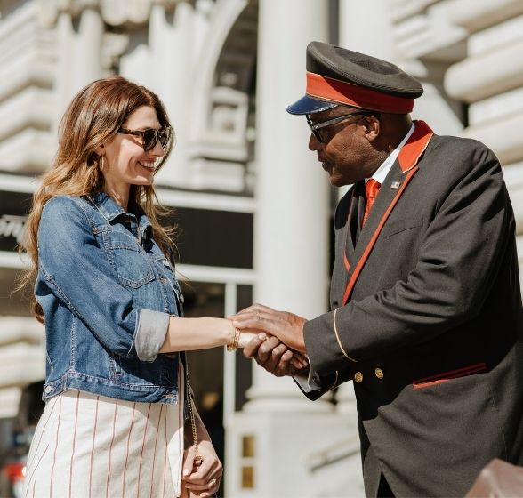 Doorman assisting Female Guest with Valet Parking